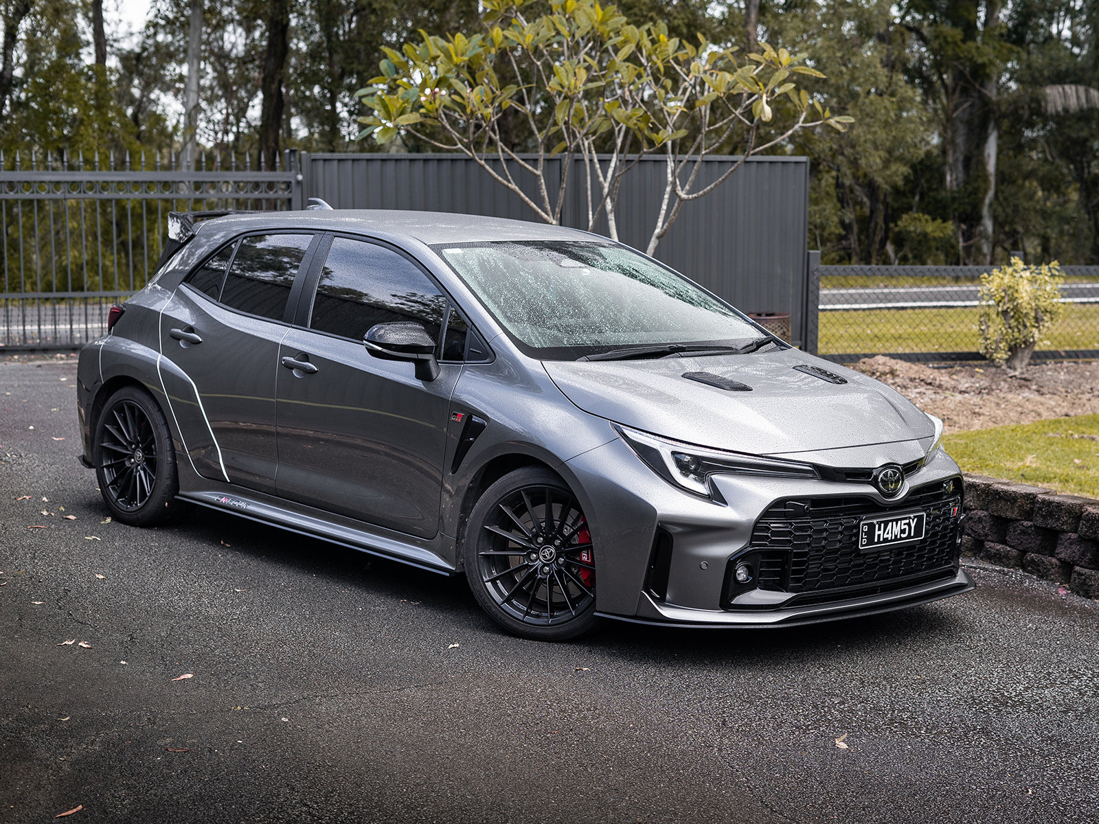 Side view showing full lip kit including front lip, side skirts, and rear spats.