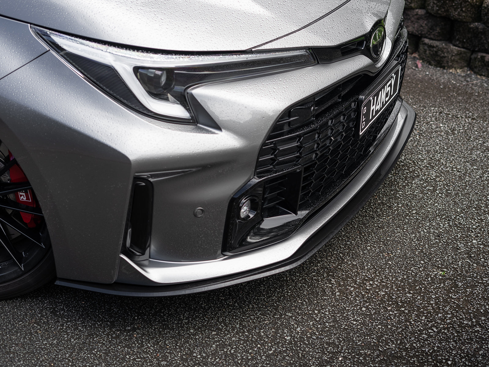 Satin black finish of splitter kit contrasting GR Corolla’s paint.