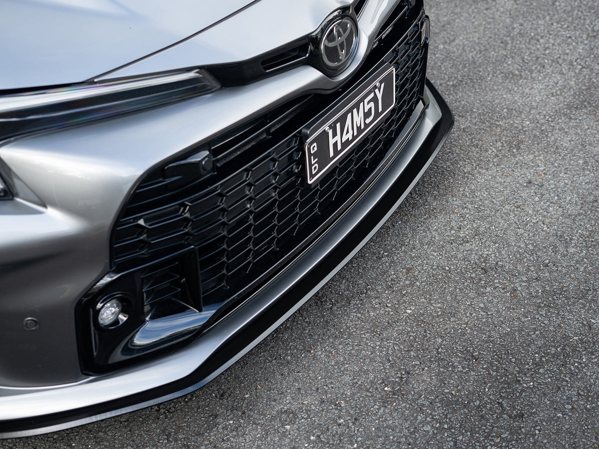 Close-up of the GR Corolla front lip splitter detail, highlighting clean fitment.