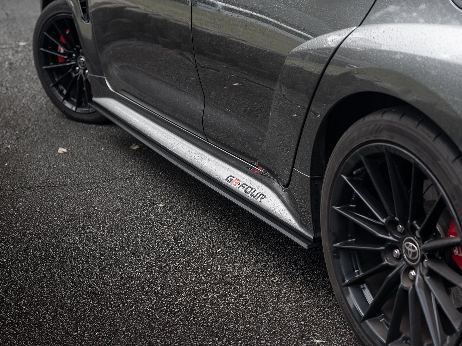 Side skirt extension visually lowering GR Corolla stance.