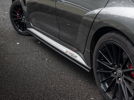 Side skirt extension visually lowering GR Corolla stance.