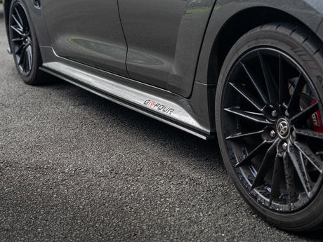 Low angle view highlighting the contour and edge of the side skirt extensions.