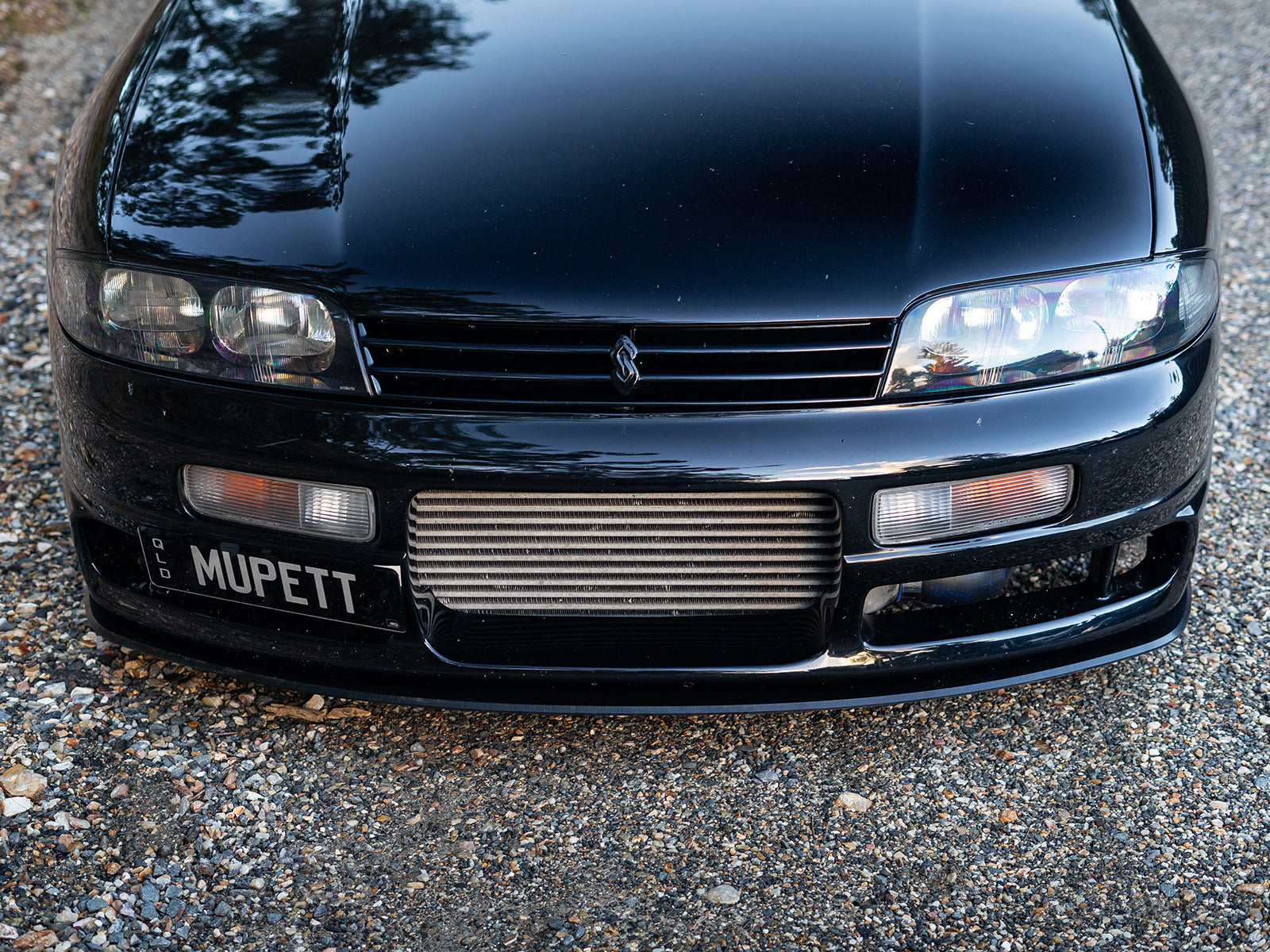 Front view of Nissan R33 with Project Aero M-Spec lip installed
