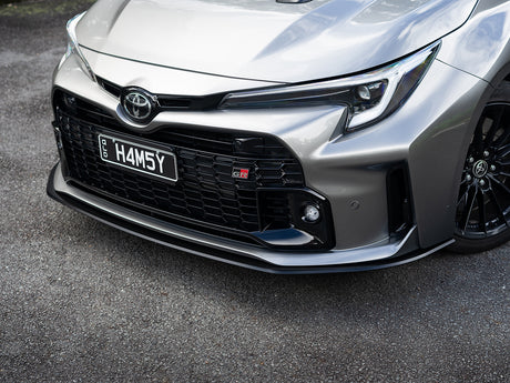 GR Corolla front lip shot from ground level to show depth and clearance.
