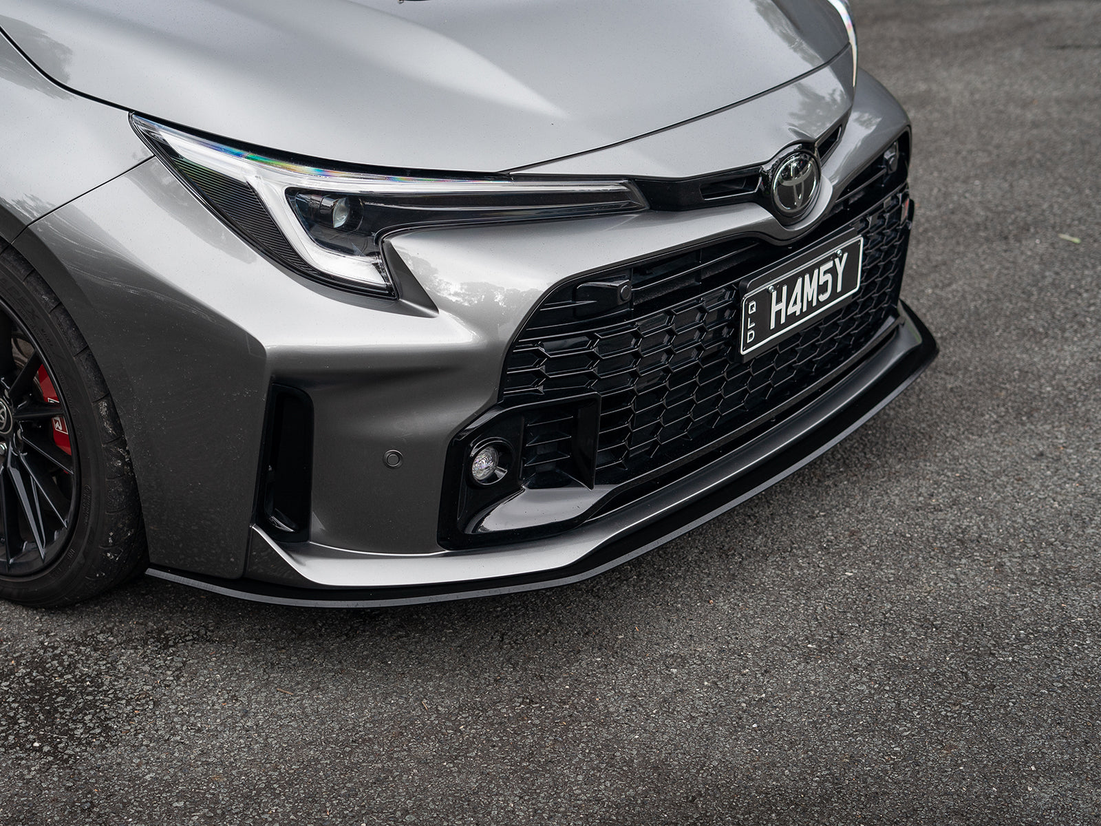 Low front view of GR Corolla showing enhanced stance with aerodynamic front lip installed.
