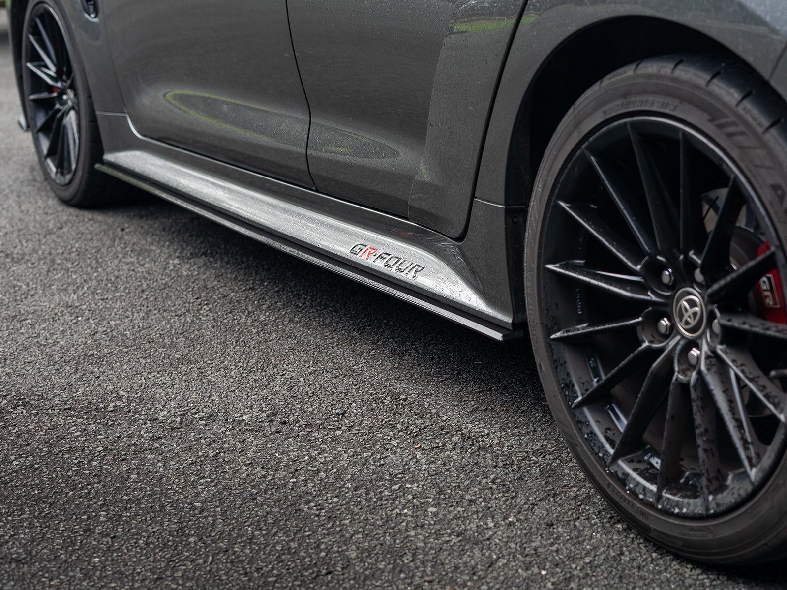 Low angle view highlighting the contour and edge of the side skirt extensions.
